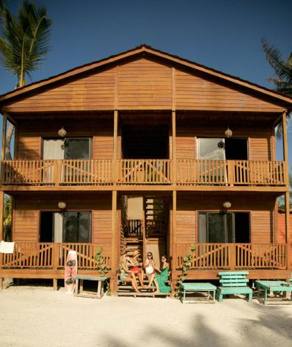 two people sitting on the porch of a house at El Regalo El Cuyo in El Cuyo