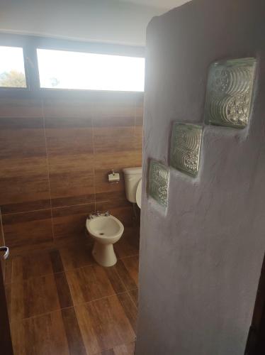 a bathroom with a toilet and a sink at Posada de las Viñas in Tolombón