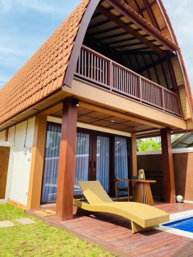 a small house with a deck and a patio at Bhumi Lovina Residence & Villa in Singaraja
