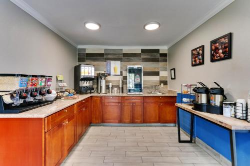 a large kitchen with wooden cabinets and a counter at Captains Quarters Inn in Port Aransas