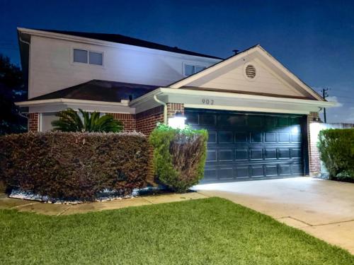 a house with a garage with two garage doors at Modern Chic Home in Channelview