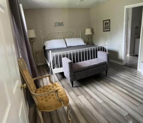 a bedroom with a bed and a chair at Asheville Vacation House in Weaverville