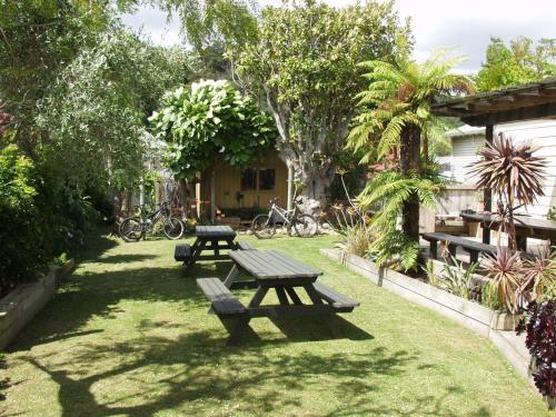 two picnic tables in the grass in a garden at Lady Bowen Bed & Breakfast in Thames