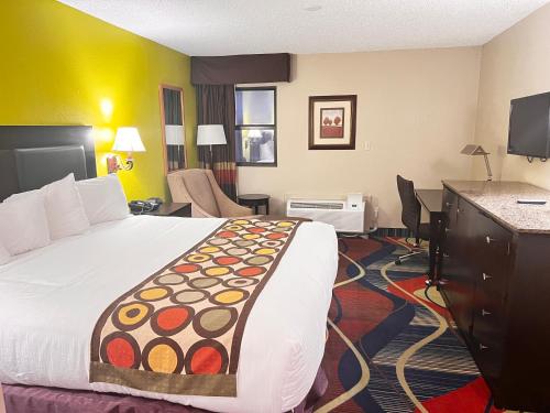 a hotel room with a bed and a desk at Apple Tree Inn in Independence