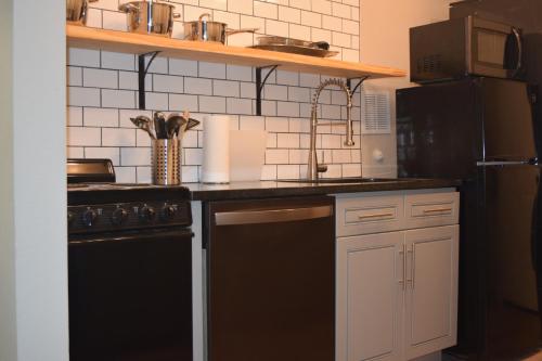 a kitchen with a black refrigerator and a black dishwasher at Lake front Studio in Little Elm