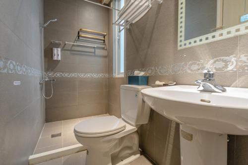 a bathroom with a toilet and a sink at Hualien Feel at Home BnB in Hualien City