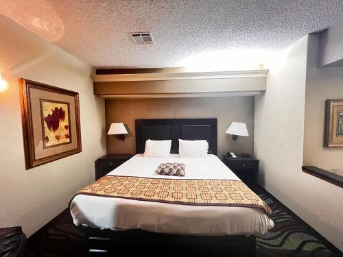 a hotel room with a large bed in it at Apple Tree Inn in Independence
