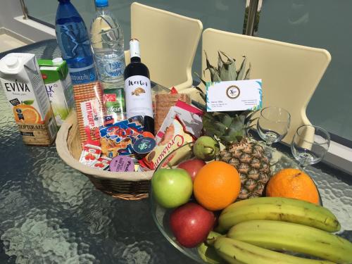 a table with a bowl of fruit and a basket of drinks at Xenos Villa 2 With 5 Bedrooms private swimming pool, near the sea in Tigaki