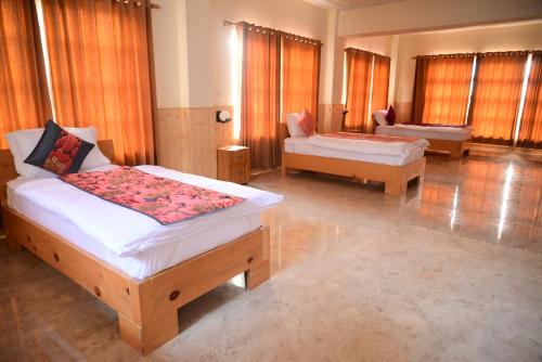 a bedroom with two beds and a couch at Munsyari The Roof Top in Munsyari