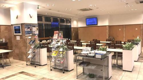 a restaurant with tables and chairs in a room at Toyoko Inn Hiroshima Heiwa-odori in Hiroshima