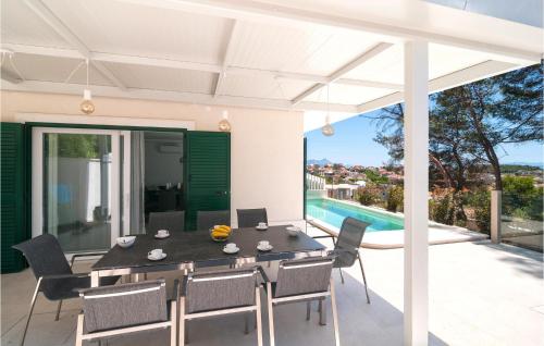 a dining room with a table and chairs on a patio at Stunning Home In Sumartin in Sumartin