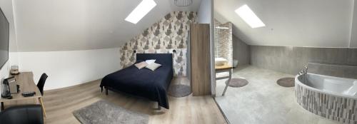 1 dormitorio con 1 cama y bañera en una habitación en Le Gîte du père Chayoux, en Champillon