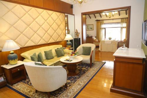 a living room filled with furniture and a large window at Taj Malabar Resort & Spa, Cochin. in Cochin