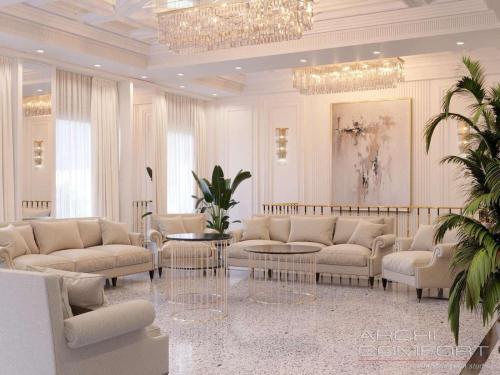a living room with white furniture and a chandelier at Anga Yerevan Hotel in Yerevan