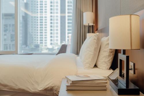 a hotel room with a bed with a large window at LOTTE City Hotel Mapo in Seoul