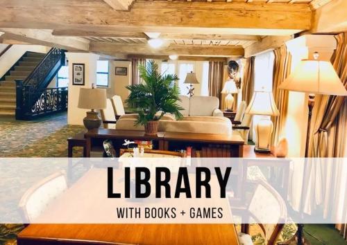 a living room with a library with books and games at King Bed Mermaid suite - heart of Palm Beach, free parking included in Palm Beach