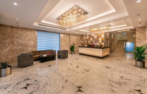 a lobby with a couch and a table in a building at Lords Inn Jaipur in Jaipur