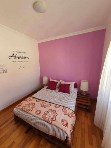 a bedroom with two beds and purple walls at Zabava Odivelas in Odivelas
