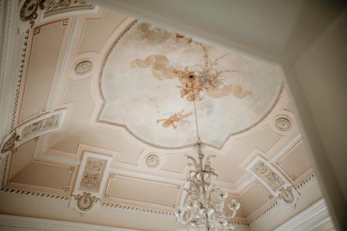a ceiling with a chandelier in a room at Lex Suites in Catania