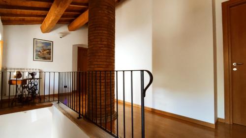 a brick column in a room with a staircase at A 2 Passi dal Lago in Grotte di Castro