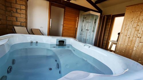 a large bath tub sitting in a room at A 2 Passi dal Lago in Grotte di Castro