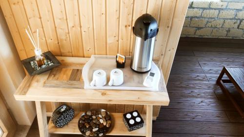 a small wooden table with a coffee maker on it at A 2 Passi dal Lago in Grotte di Castro