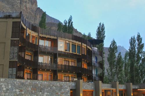 a building in front of a mountain at Famree Resort Hunza in Hunza Valley
