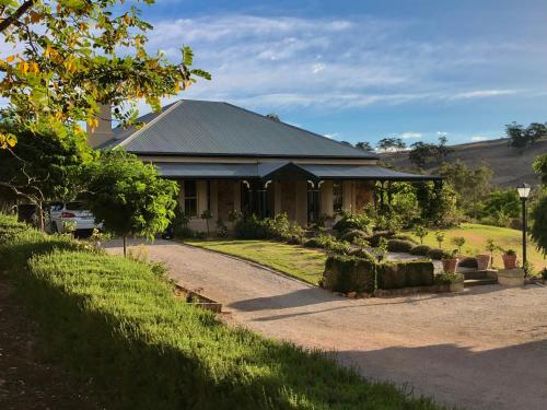 a house with a driveway in front of it at Battunga Cottages in Watervale