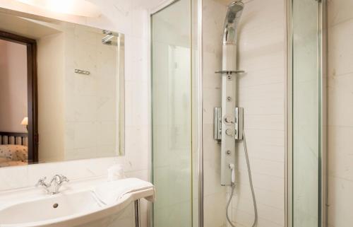 a bathroom with a shower and a sink at Spilia Village Hotel & Villas in Spiliá