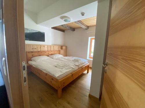 a small bedroom with a bed in a room at Gasthaus Post in Matrei in Osttirol