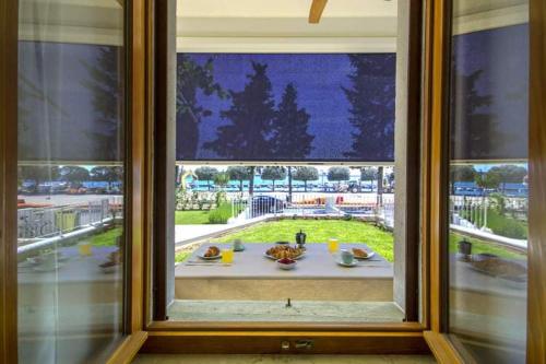 a window with a view of a table with food at Apartment Derossi in Umag