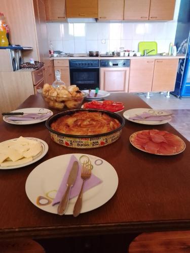 a table with plates of food on top of it at Camp &Apartmens Scepanovic in Mojkovac