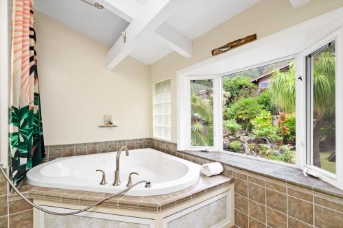 uma casa de banho com uma banheira e uma janela em Seabreeze Hawaii Kai em Honolulu