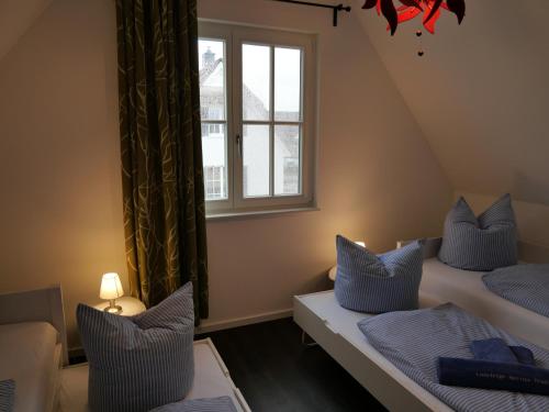A bed or beds in a room at dicht an der Küste Haus "Emma" mit Infrarot-Sauna uWallbox