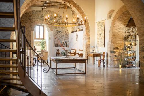 a living room with a staircase and a chandelier at Tenuta Ciminata Greco in Rossano