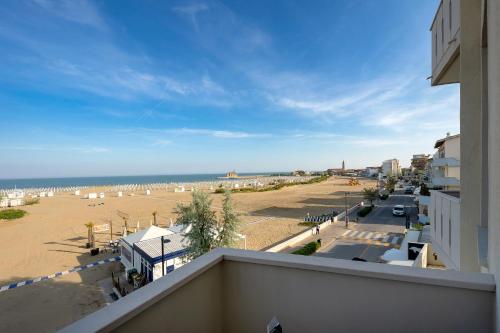 a view of a beach from the balcony of a building at Hotel Delfino in Caorle