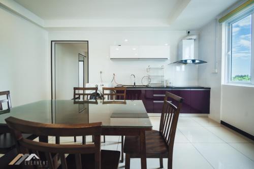 a kitchen with a dining room table and chairs at Serene Heights by Evernent in Miri