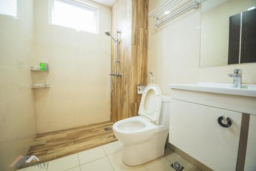 a bathroom with a toilet and a sink at Serene Heights by Evernent in Miri
