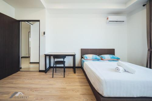 a hotel room with two beds and a table at Serene Heights by Evernent in Miri