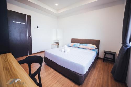 a bedroom with a bed with two pillows on it at Serene Heights by Evernent in Miri