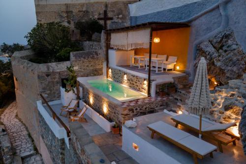 a villa with a swimming pool and a restaurant at Wind Tales in Ermoupoli