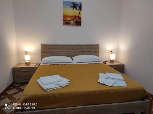a bedroom with a bed with two towels on it at Avola Holidays in Avola