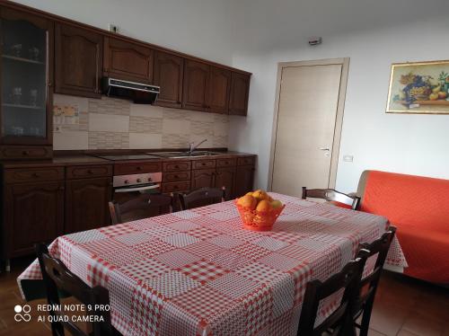 a kitchen with a table with a bowl of fruit on it at Avola Holidays in Avola