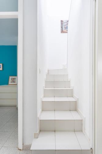 a staircase in a room with white walls at Home2Book Relax Caletillas, Terrace & Pool in Candelaria