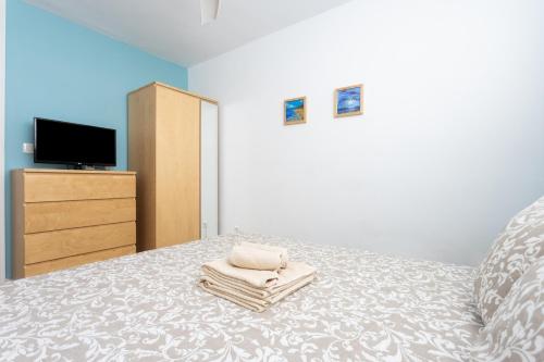 a bedroom with a bed with towels on it at Home2Book Relax Caletillas, Terrace & Pool in Candelaria