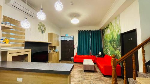 a living room with a red couch and a table at 牧雲民宿 in Jinning