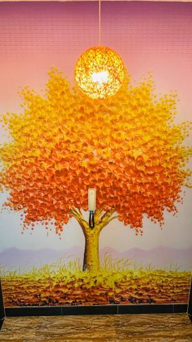 a painting of a tree with a light on it at 牧雲民宿 in Jinning