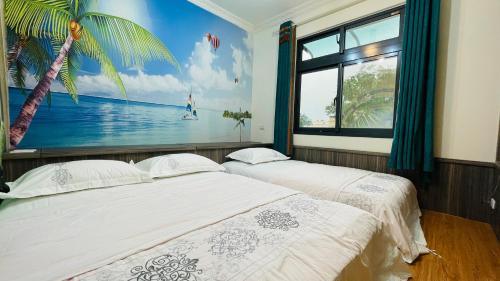 two beds in a room with a painting on the wall at 牧雲民宿 in Jinning