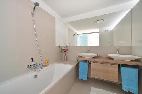 a white bathroom with two sinks and a tub at HigueronRentals Hill Manon in Benalmádena