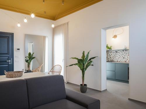 a living room with a table and a couch at Living u HomeSuites in Lecce